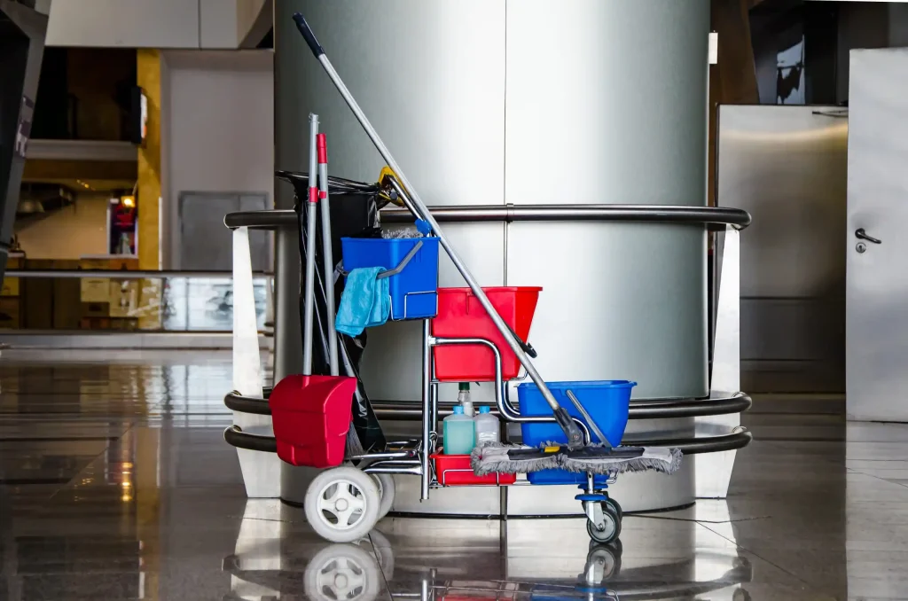 a cleaning cart with mops and buckets